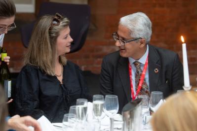 two people talking at dinner table